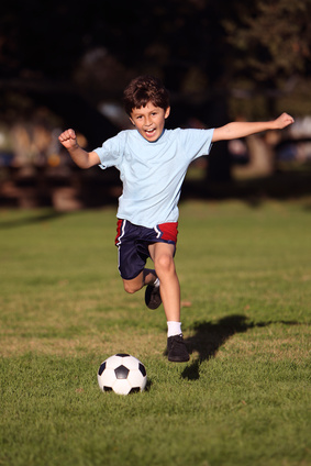 image of a kid playing soccer